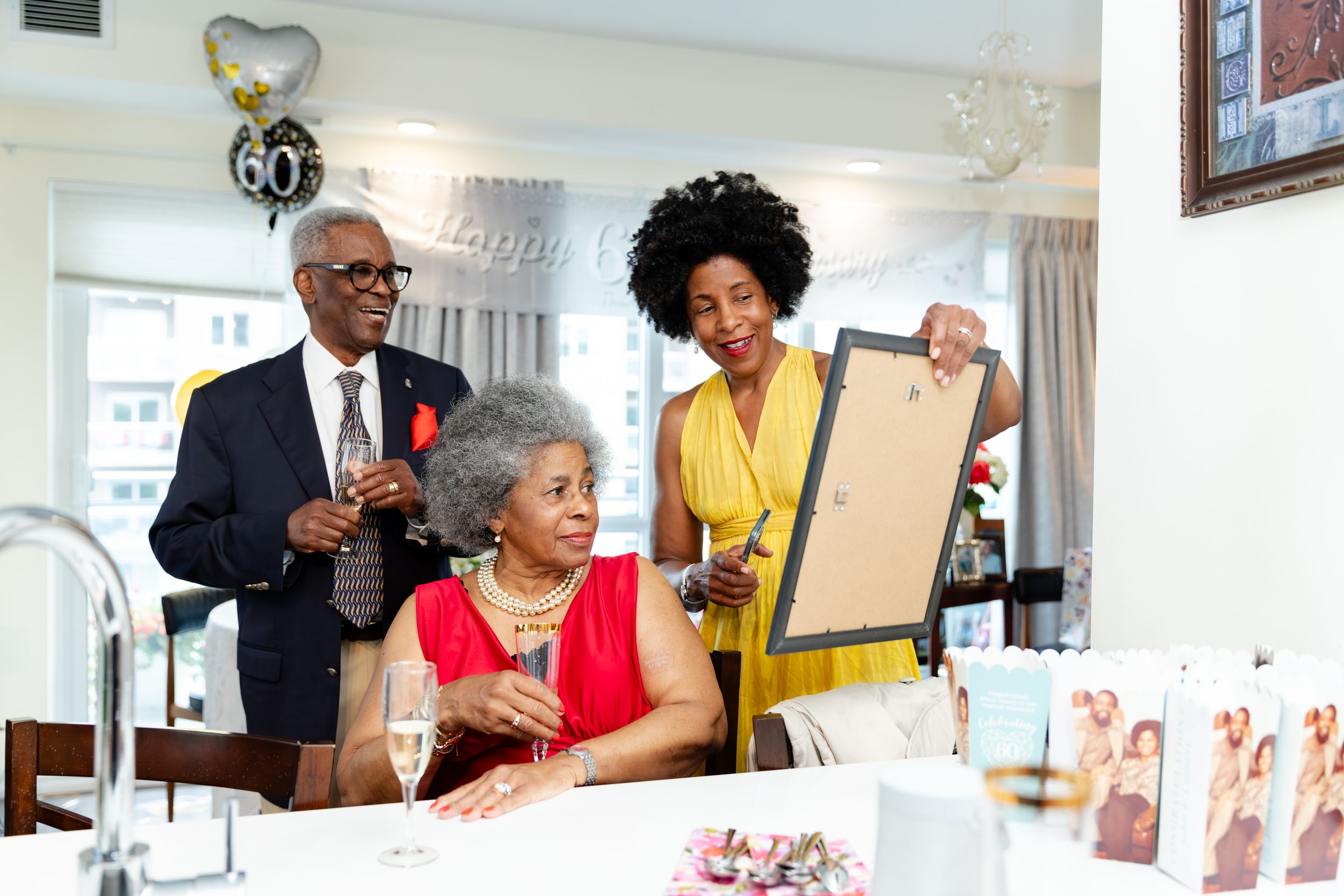 People celebrating at an elegant indoor event with decorative displays and bright lighting.