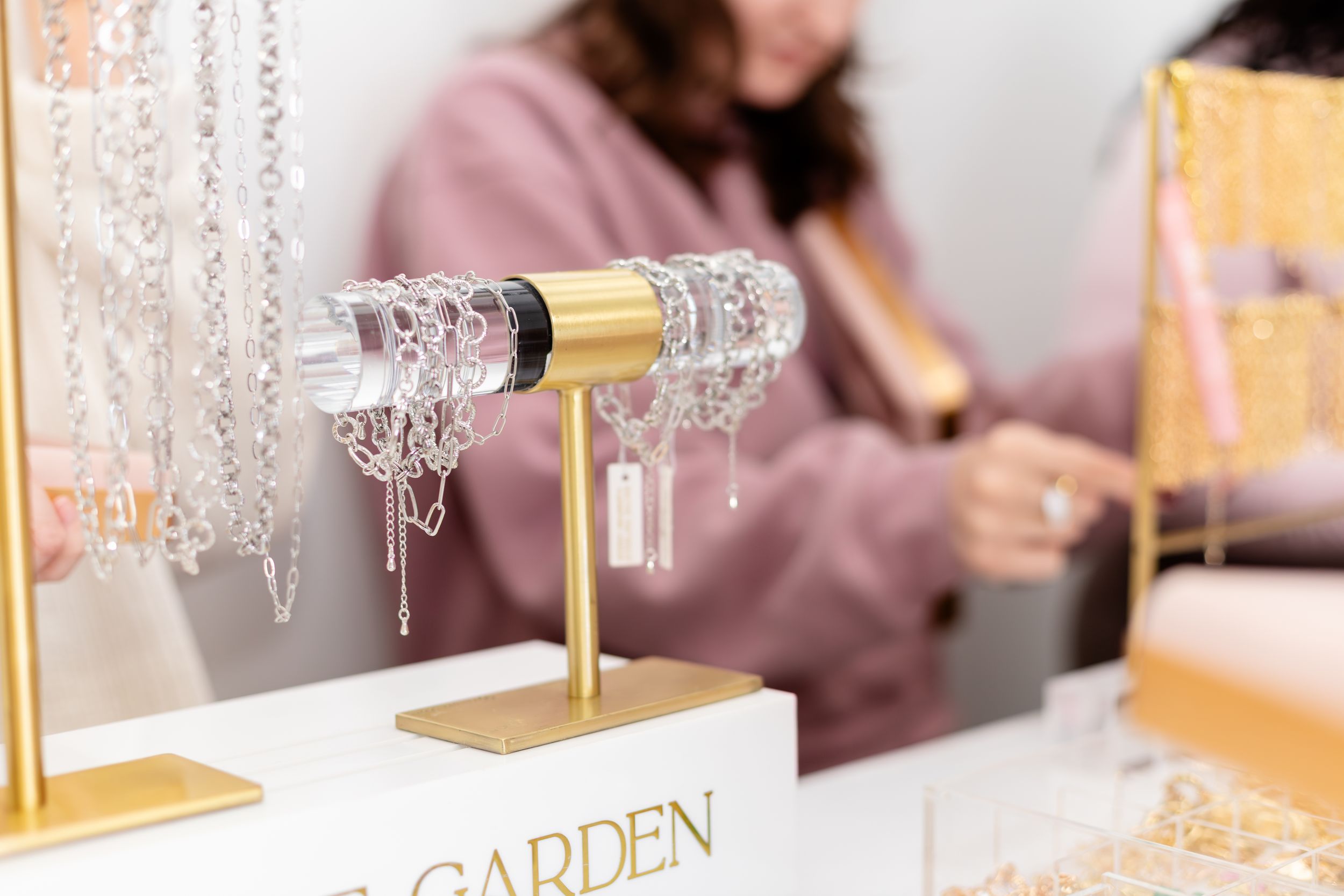 Elegant gold and crystal chandelier lighting fixture hangs above a luxurious dining table setting.