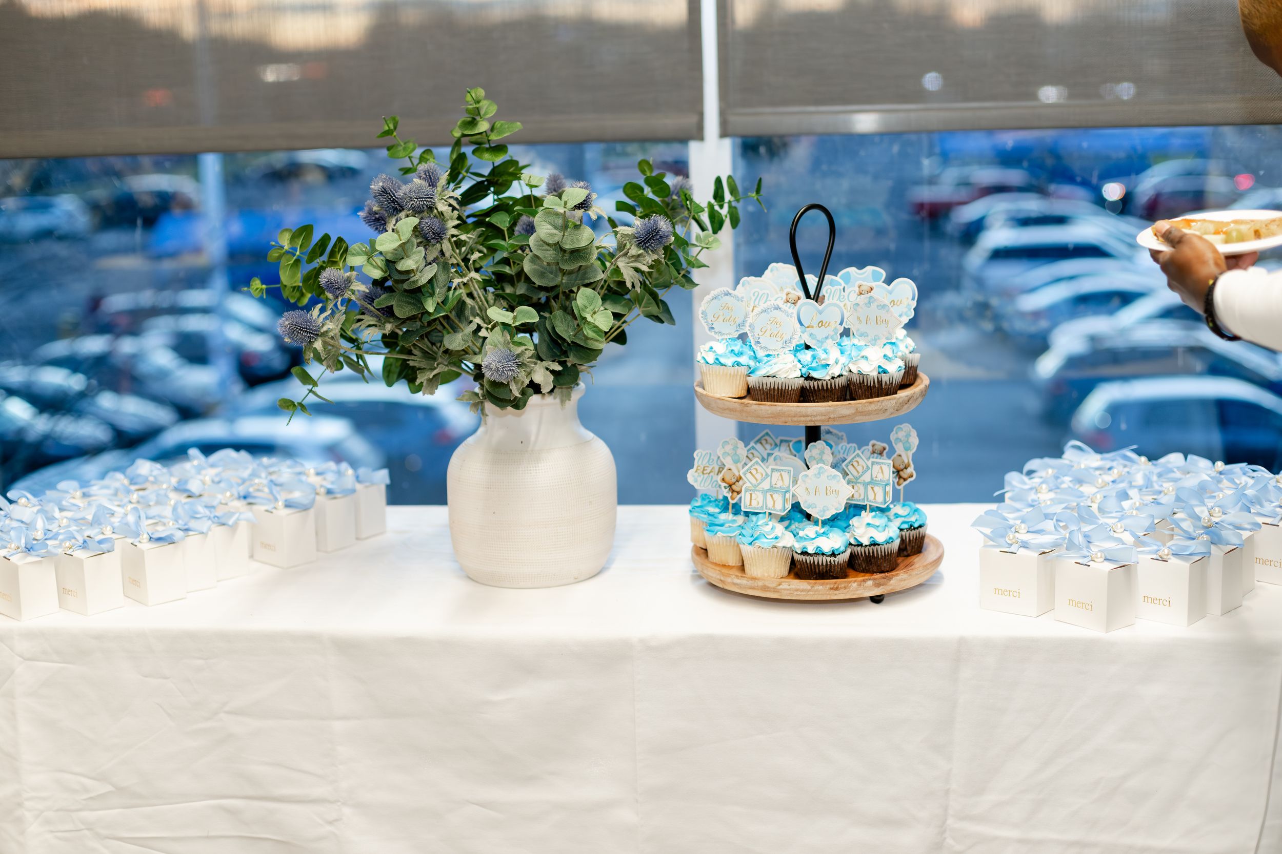 Elegant table decor featuring blue and white elements with delicate floral arrangements and succulents on a white tablecloth.