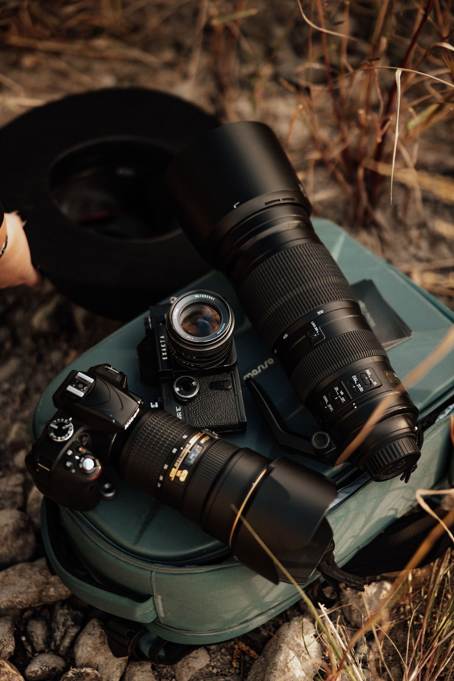 Camera equipment lying on textured concrete ground surface.
