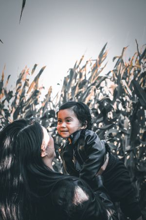 Heartwarming moment captured against cornfield backdrop.