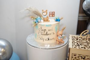 Elegant baby shower cake decorated with foxes, flowers and pampas grass.