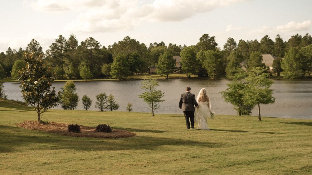 Modern couple walking hand-in-hand through Southeast Georgia’s rolling countryside — cinematic and refined.luxury