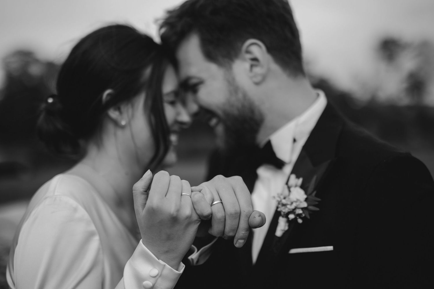 Intimate black and white moment between couple in formal attire.