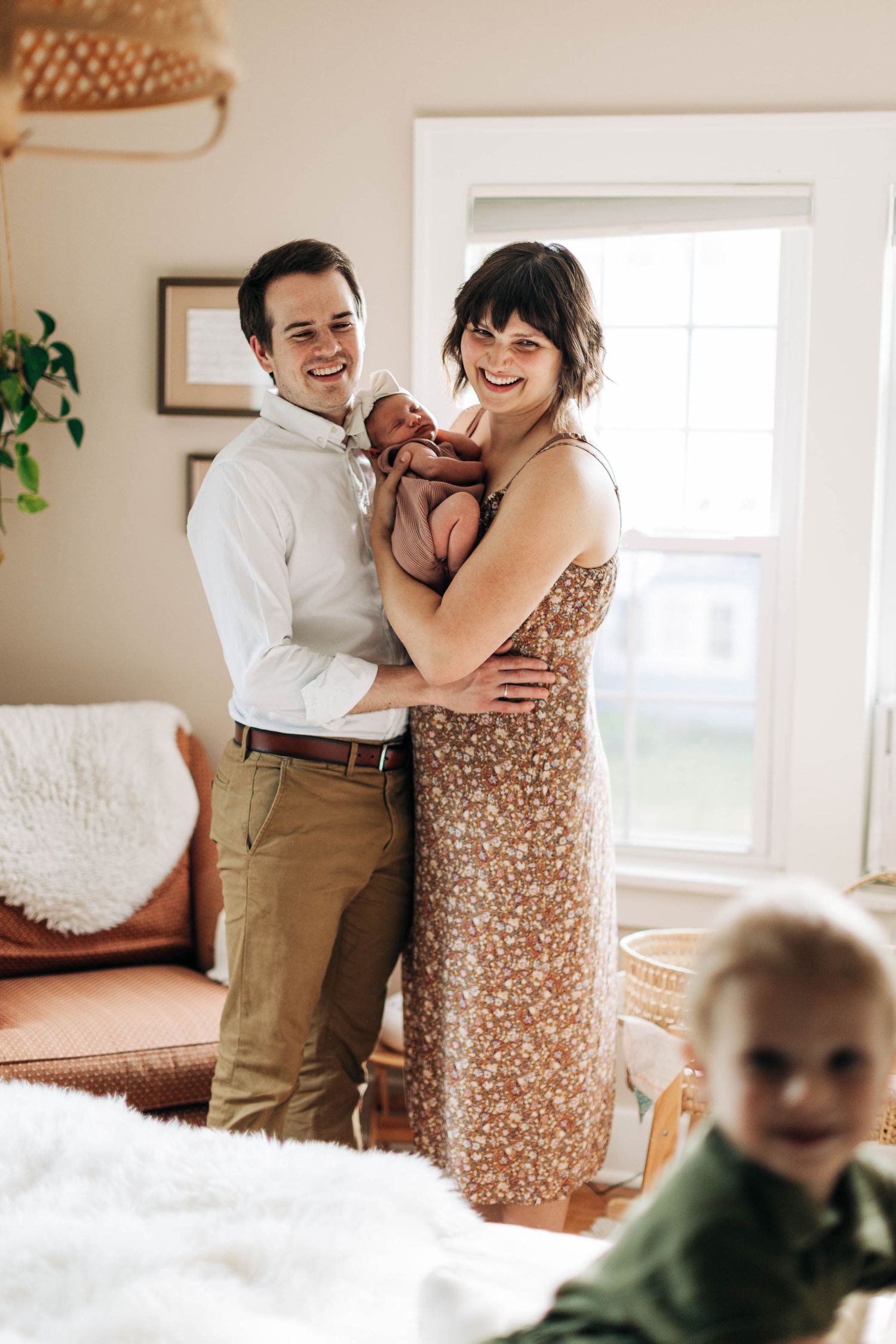 Family moment captured in a bright room with woven pendant light fixture.