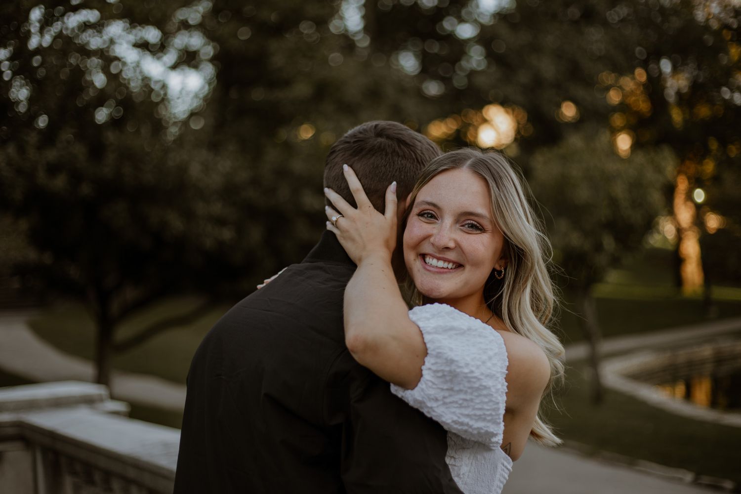 Joyful embrace during golden hour outdoor photo session.