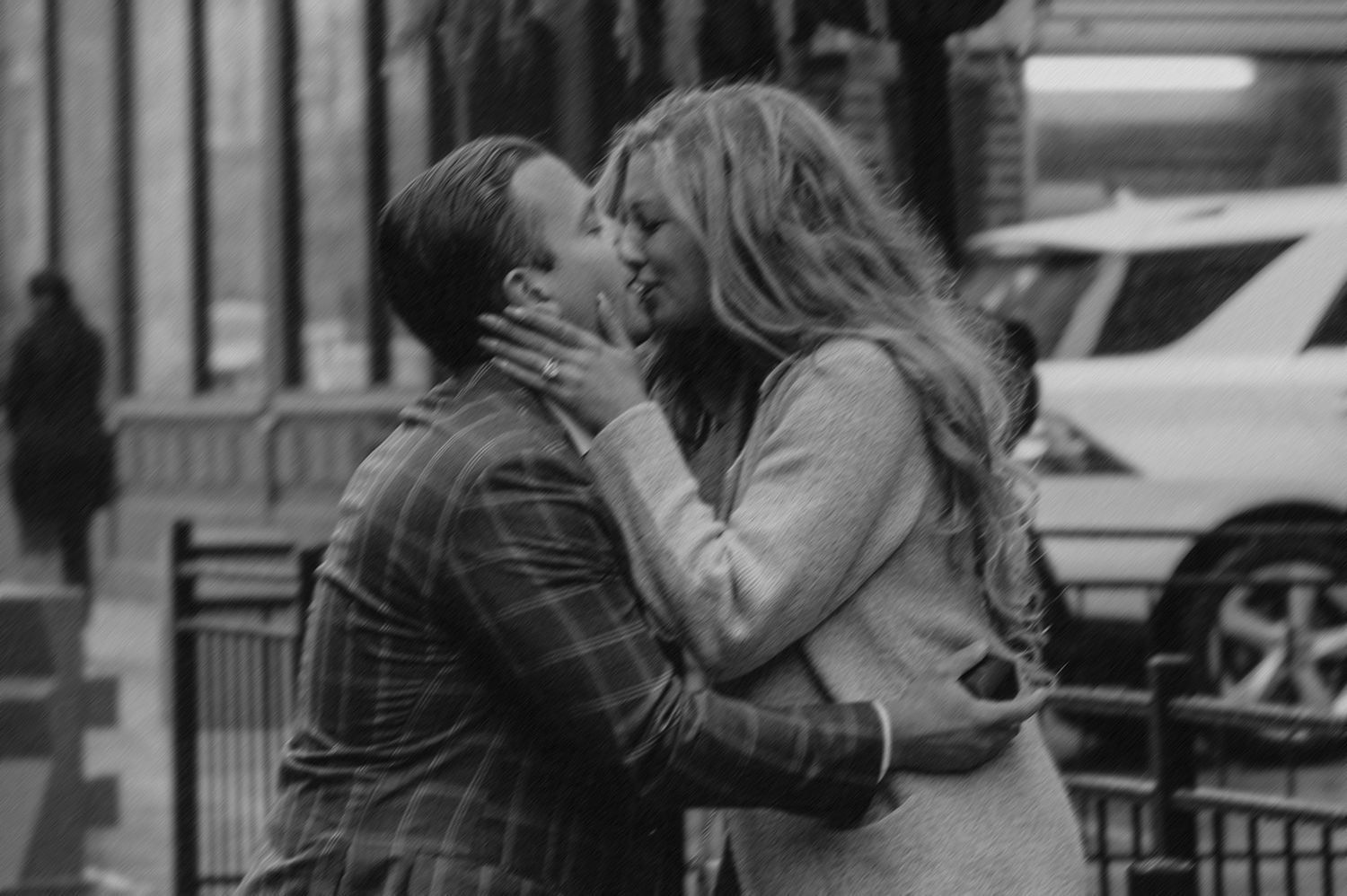 A romantic black and white sequence of a couple embracing outdoors.