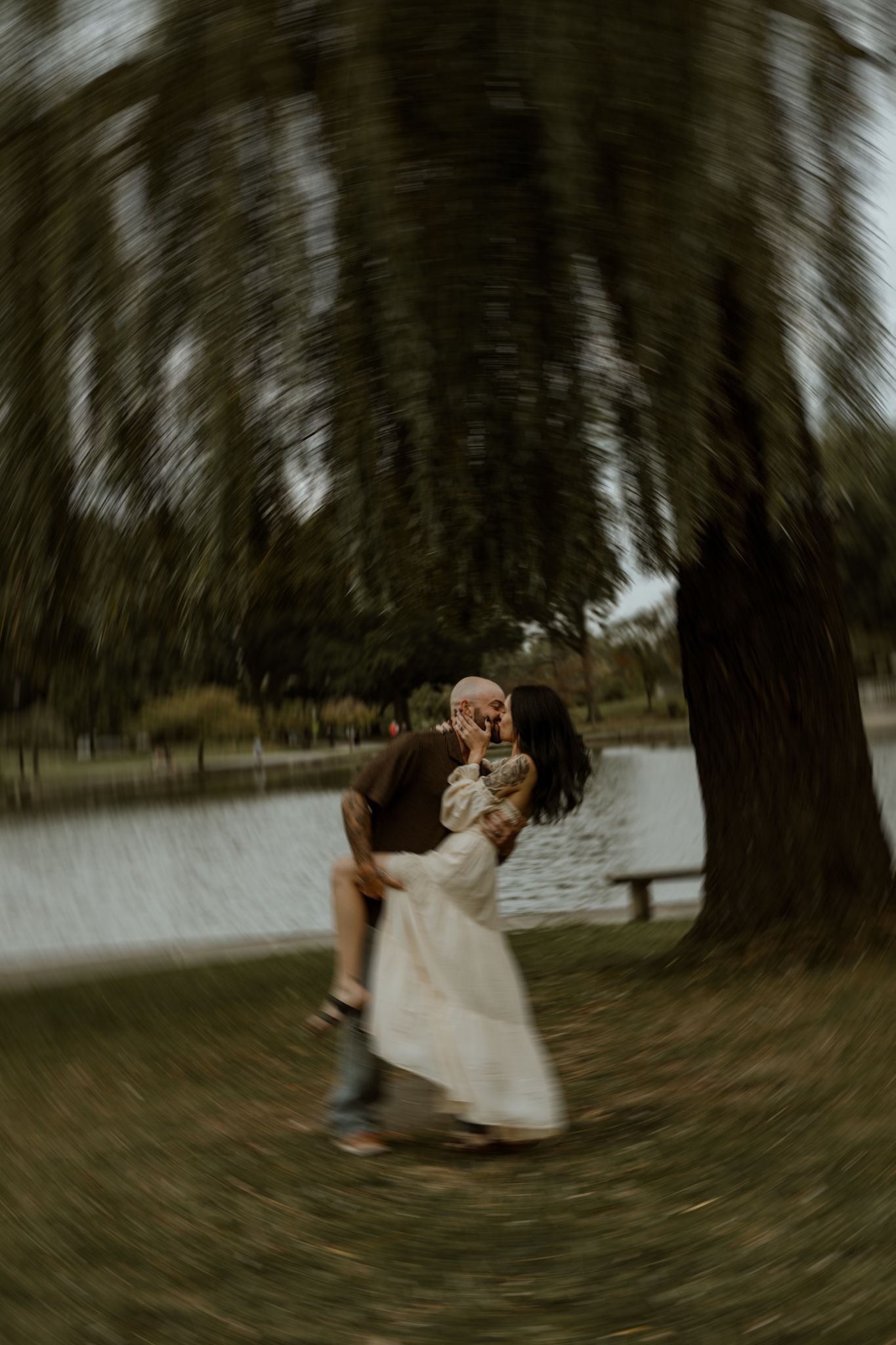 Artistic spinning motion blur photo of couple dancing in a park.