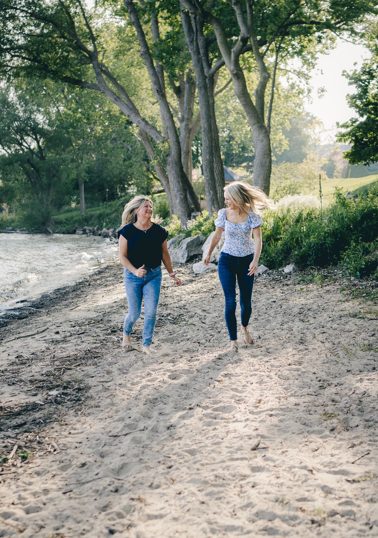 Mother and daughter running along the beach
