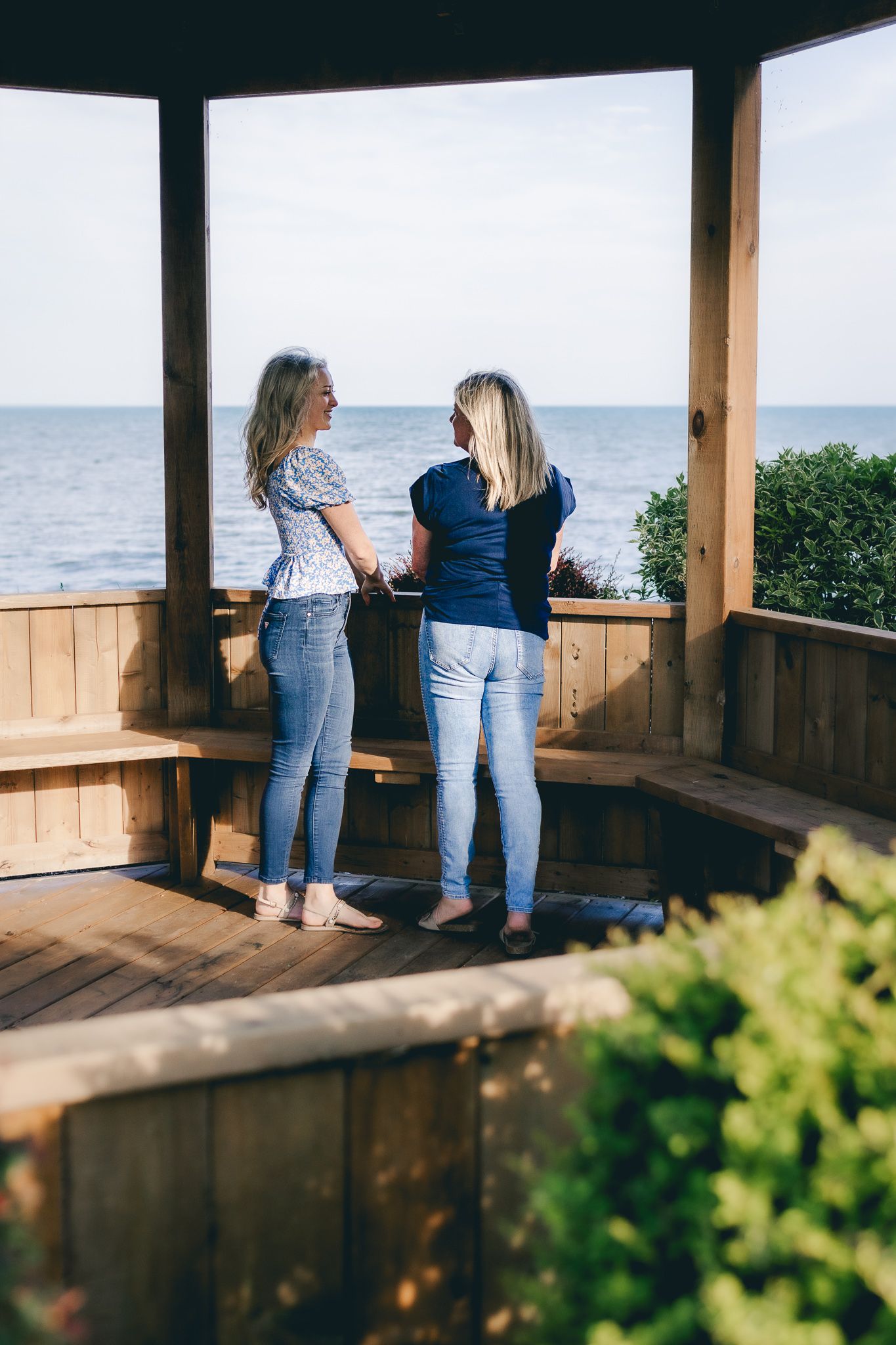 Mother and daughter looking out on the water