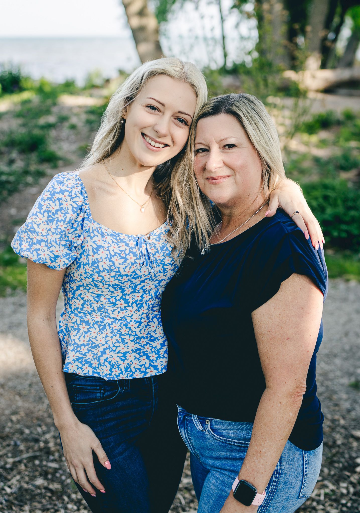 Portrait of mother and daughter side hugging