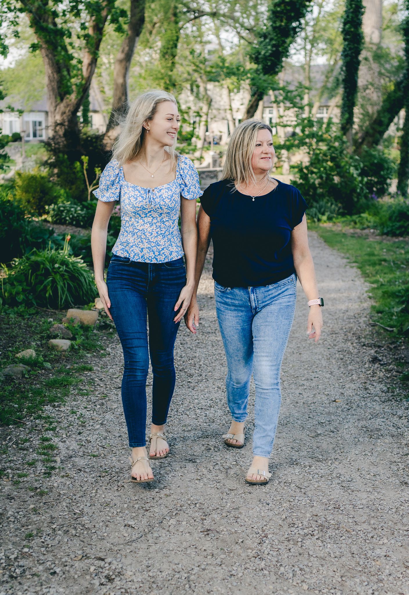 Mother and daughter walking along a garden trail