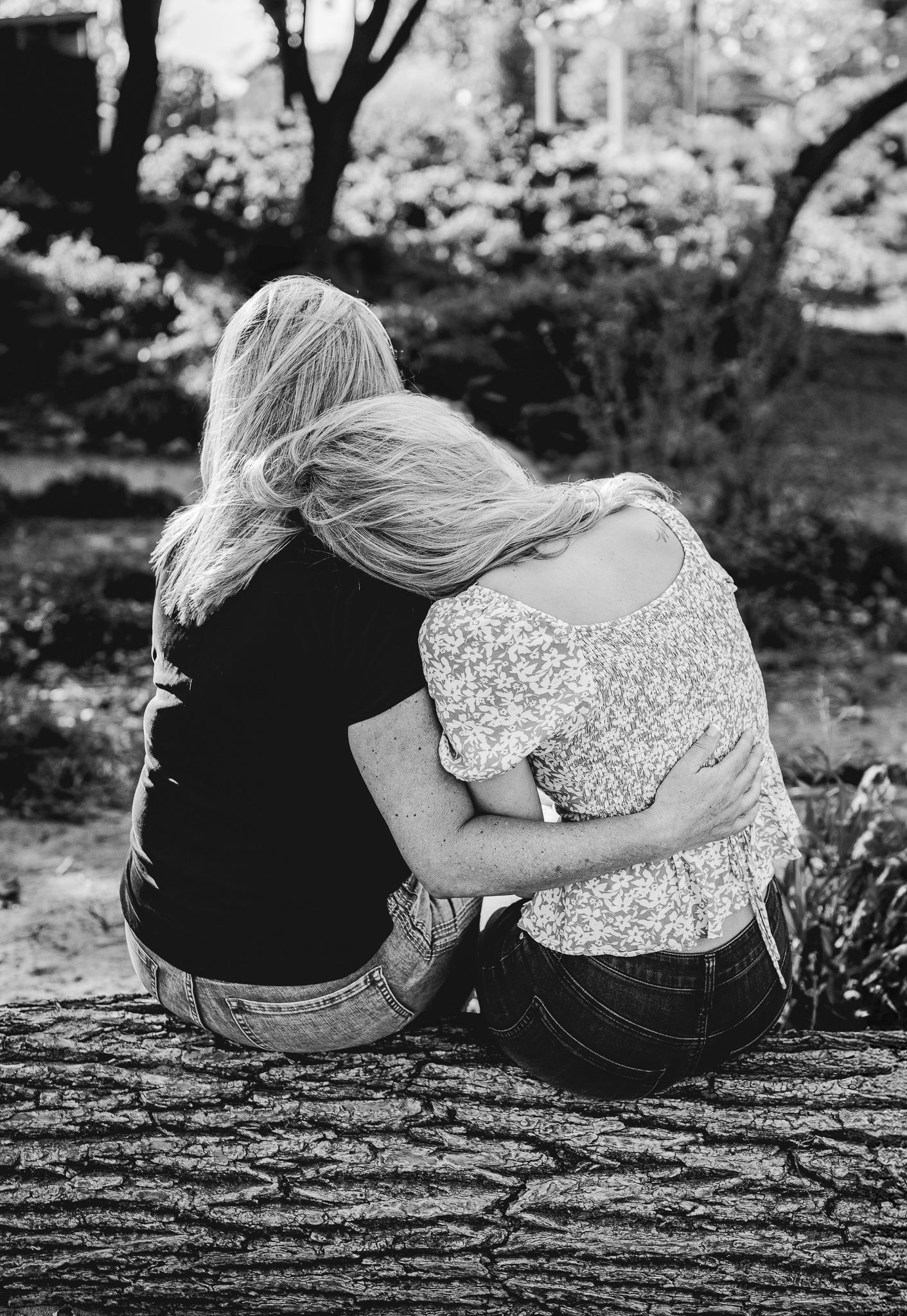 Black and white photo of a mother and daughter side hugging