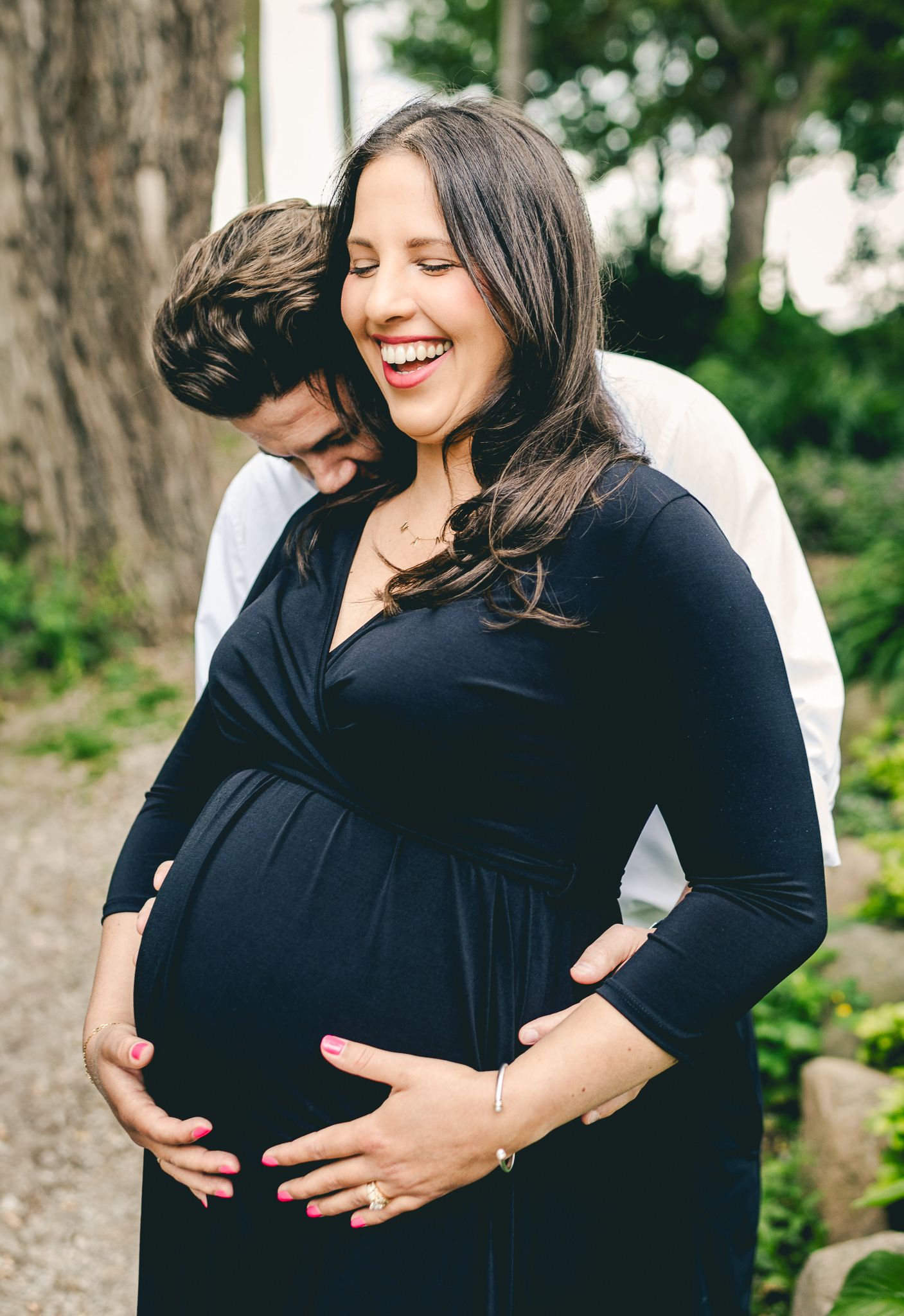 Husband holding wife's pregnant belly