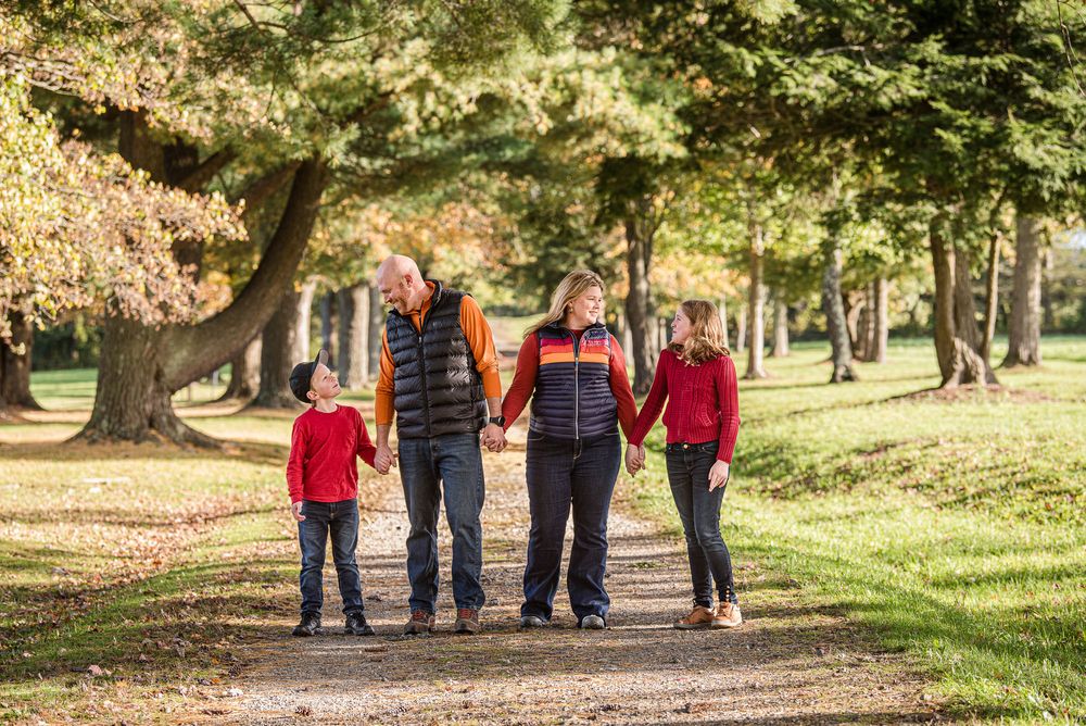 Family standing together along path in forest