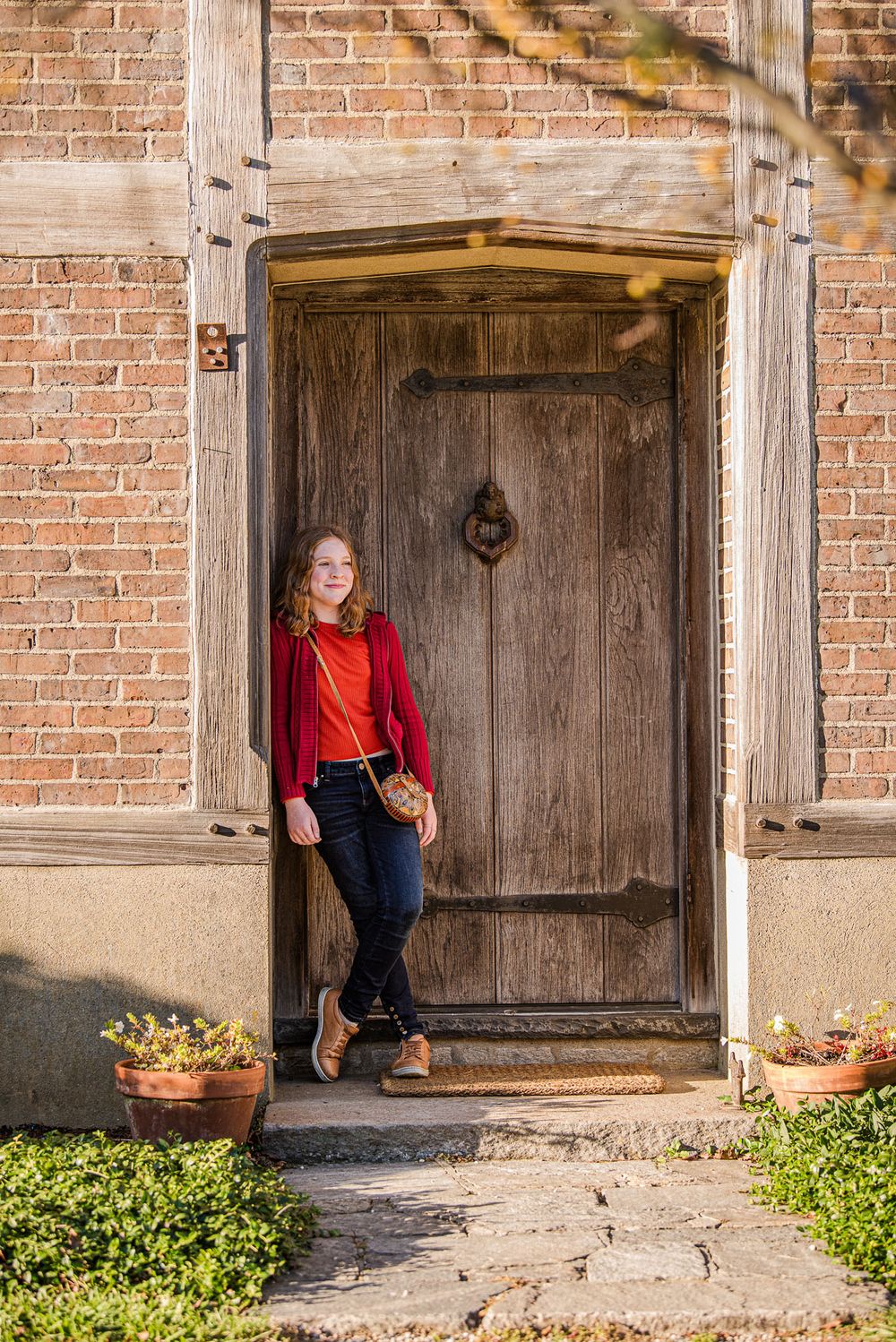 Girl smiling in the doorway of a historic house