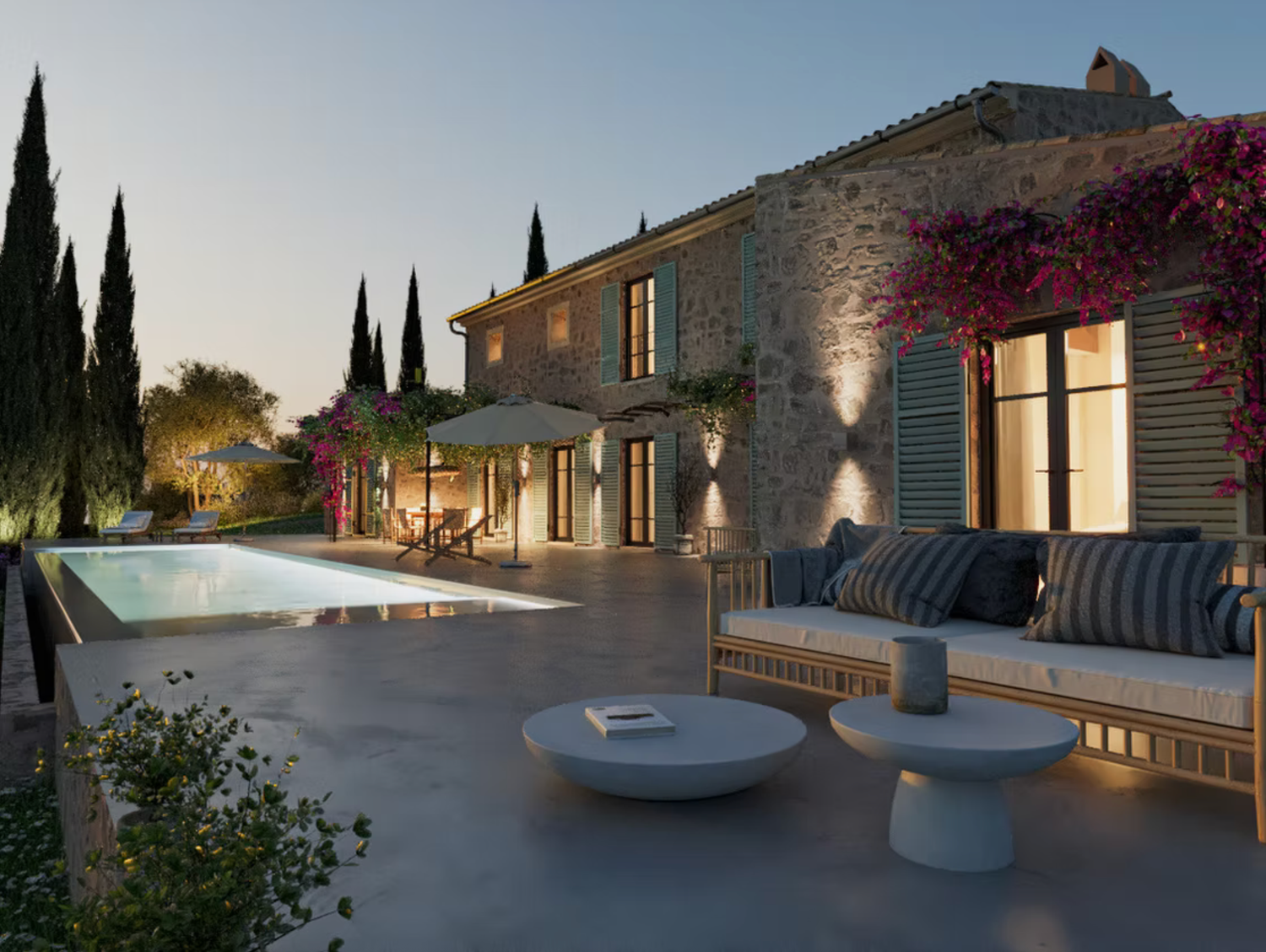 Modern villa with sun loungers beside a crystal-clear swimming pool surrounded by lush gardens.