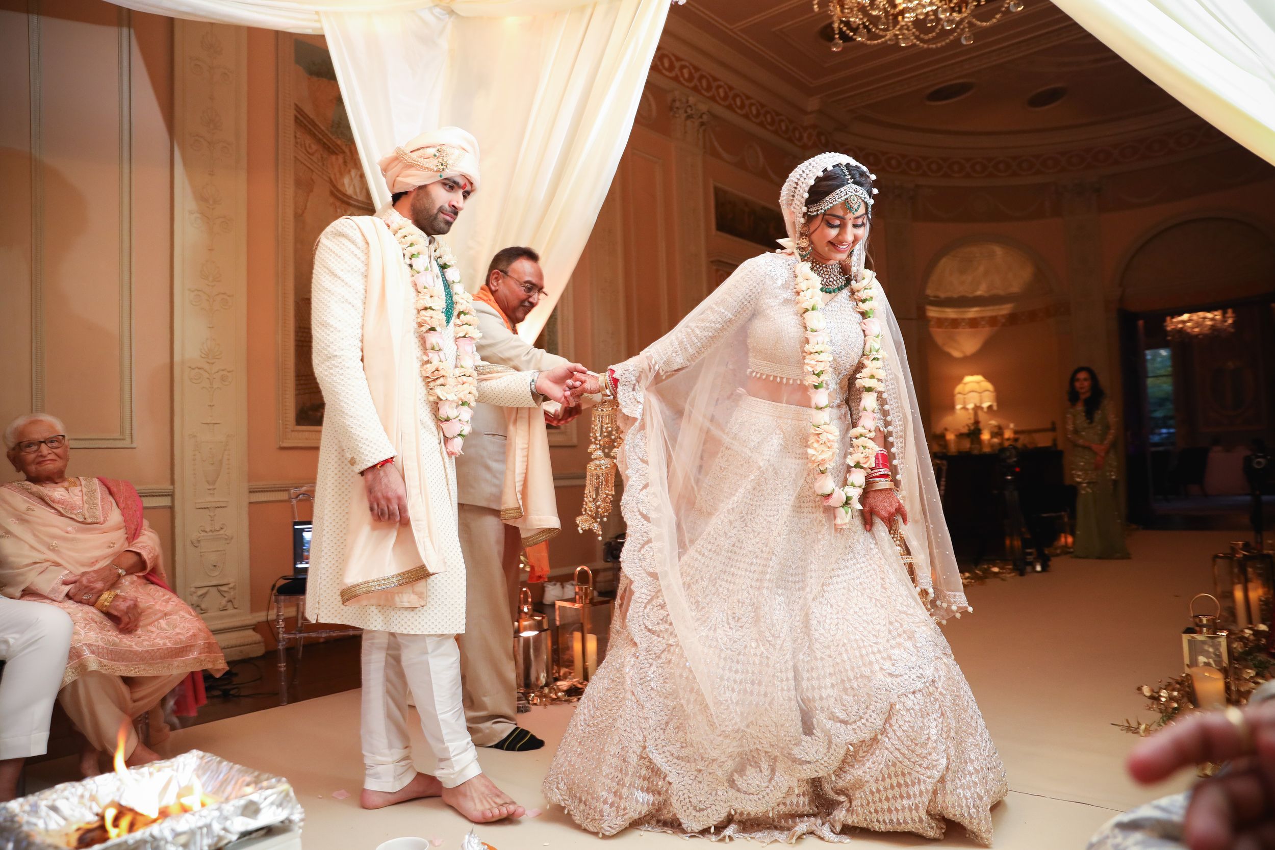 Traditional South Asian wedding ceremony with white decor and florals. Asian Wedding Photography & Videography