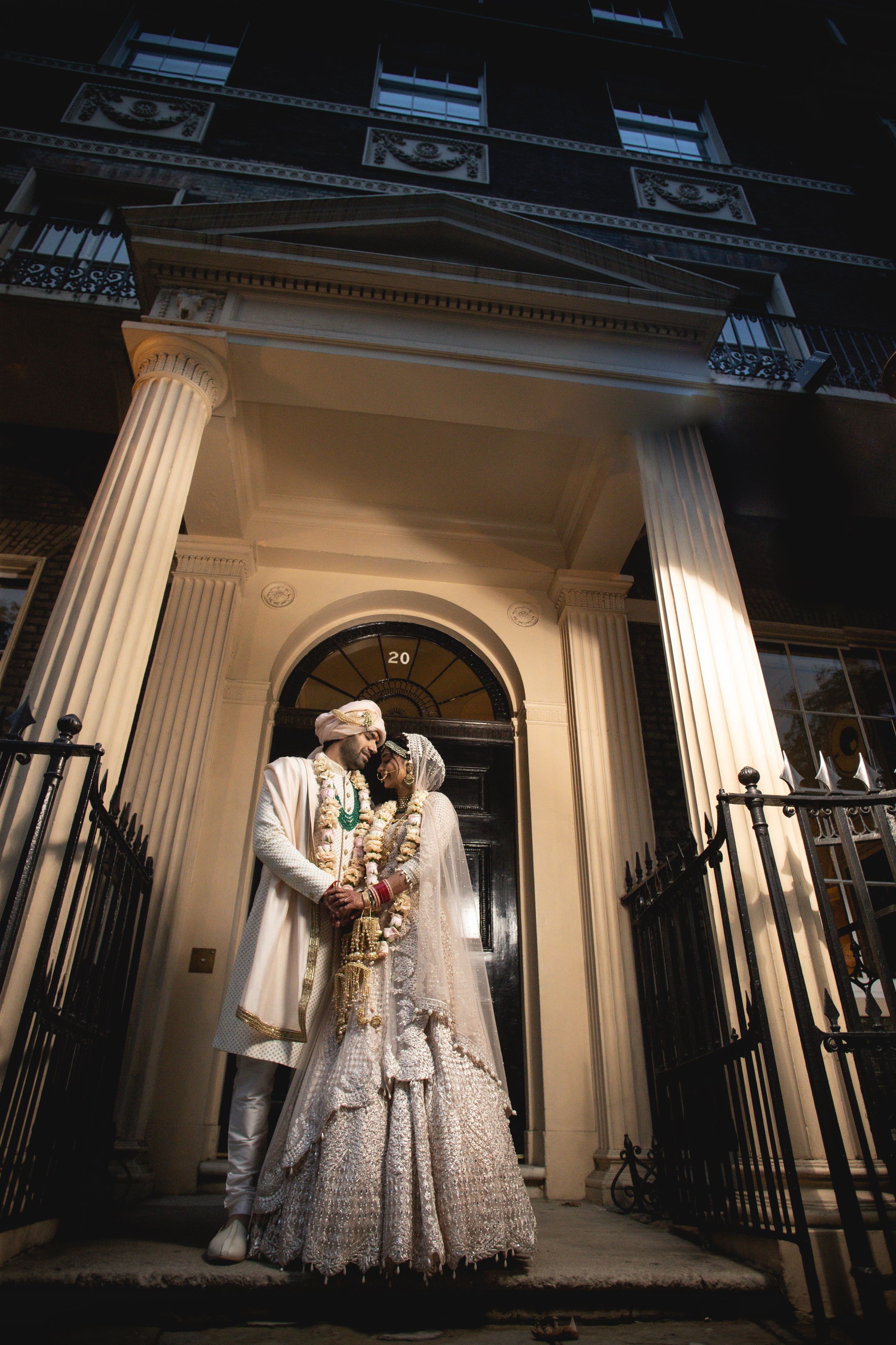 Romantic wedding portrait in front of classic white columned entrance. Asian Wedding Photography & Videography