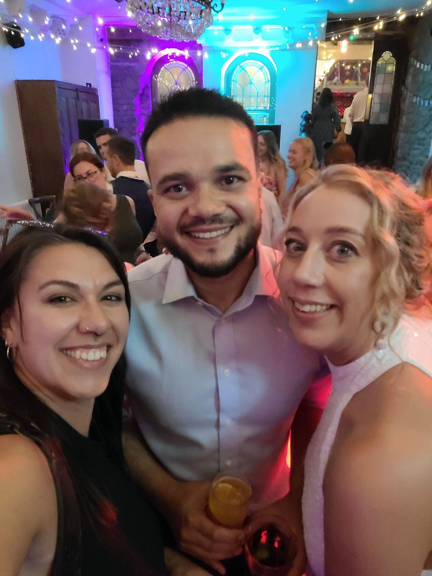 Party scene with colorful lighting and people enjoying themselves.