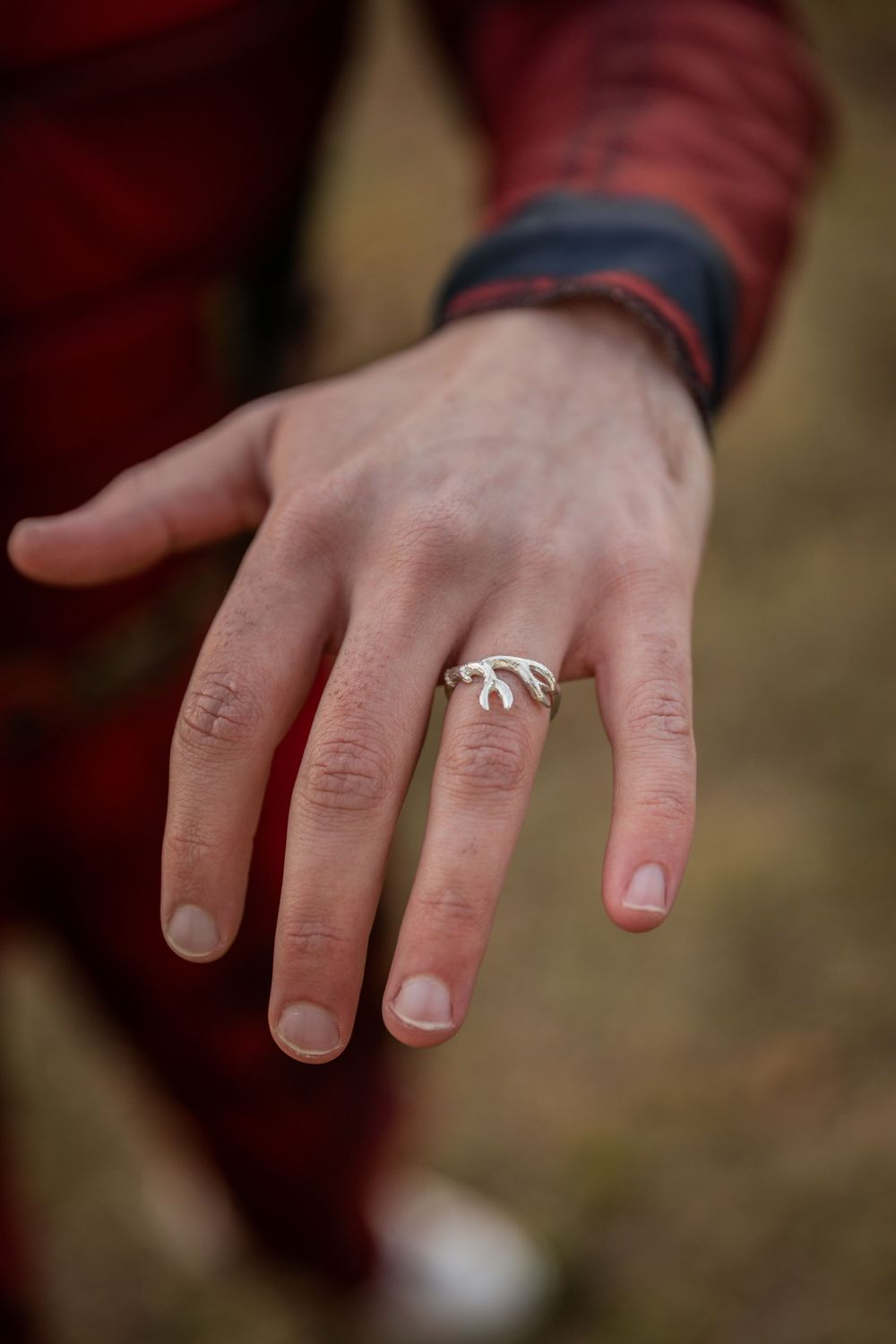 Close-up sequence showing a hand with a candy cane ring on the finger against a blurred background.