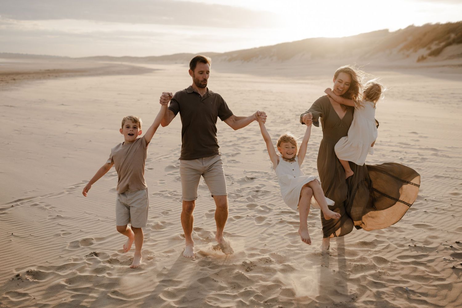 A family spending time on the beach during their family photo session with Forever Ours Photography in Kent