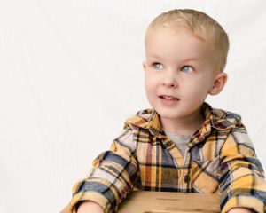Child looking happy in a family photoshoot.