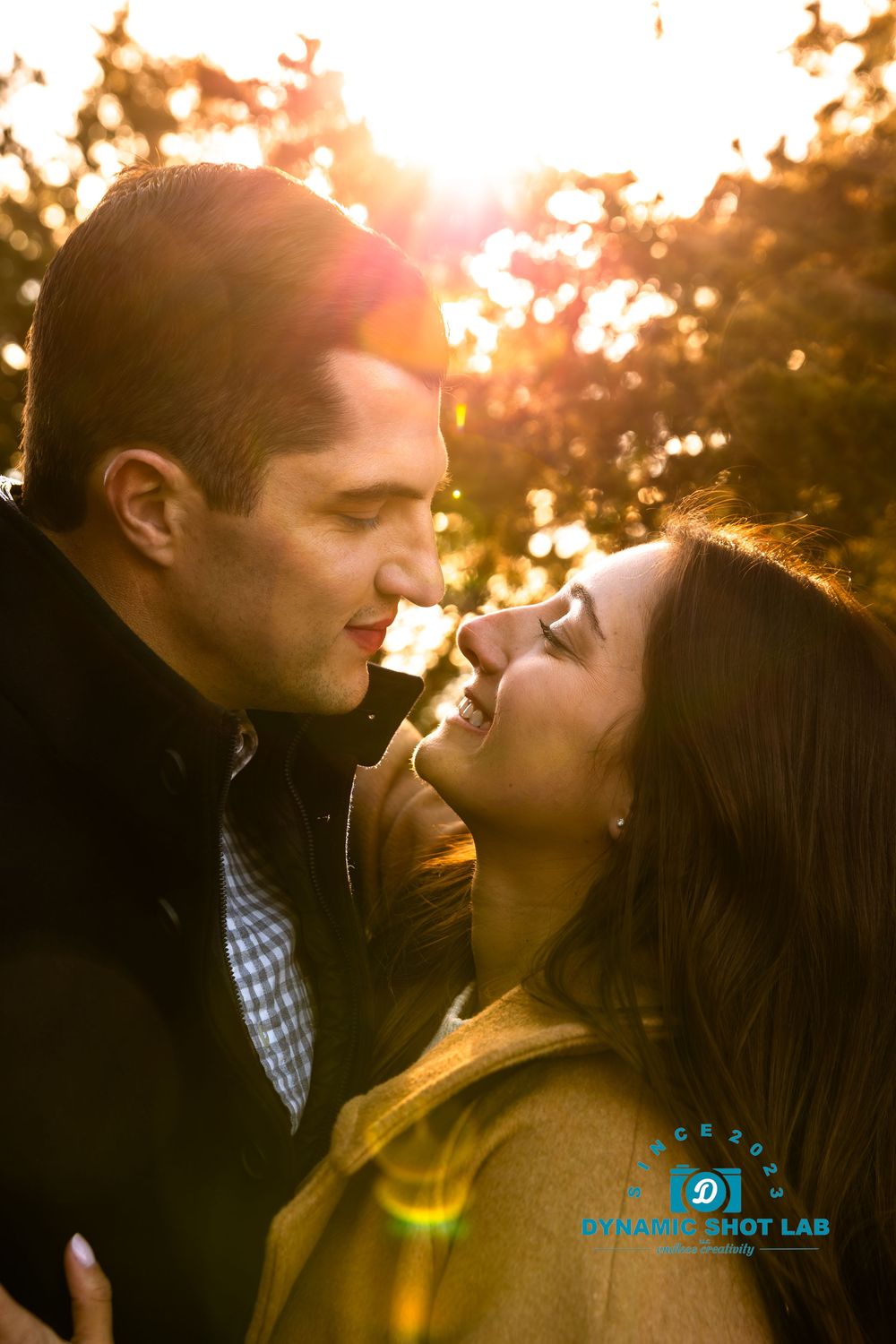 A romantic couple shares an intimate moment during golden hour sunset.