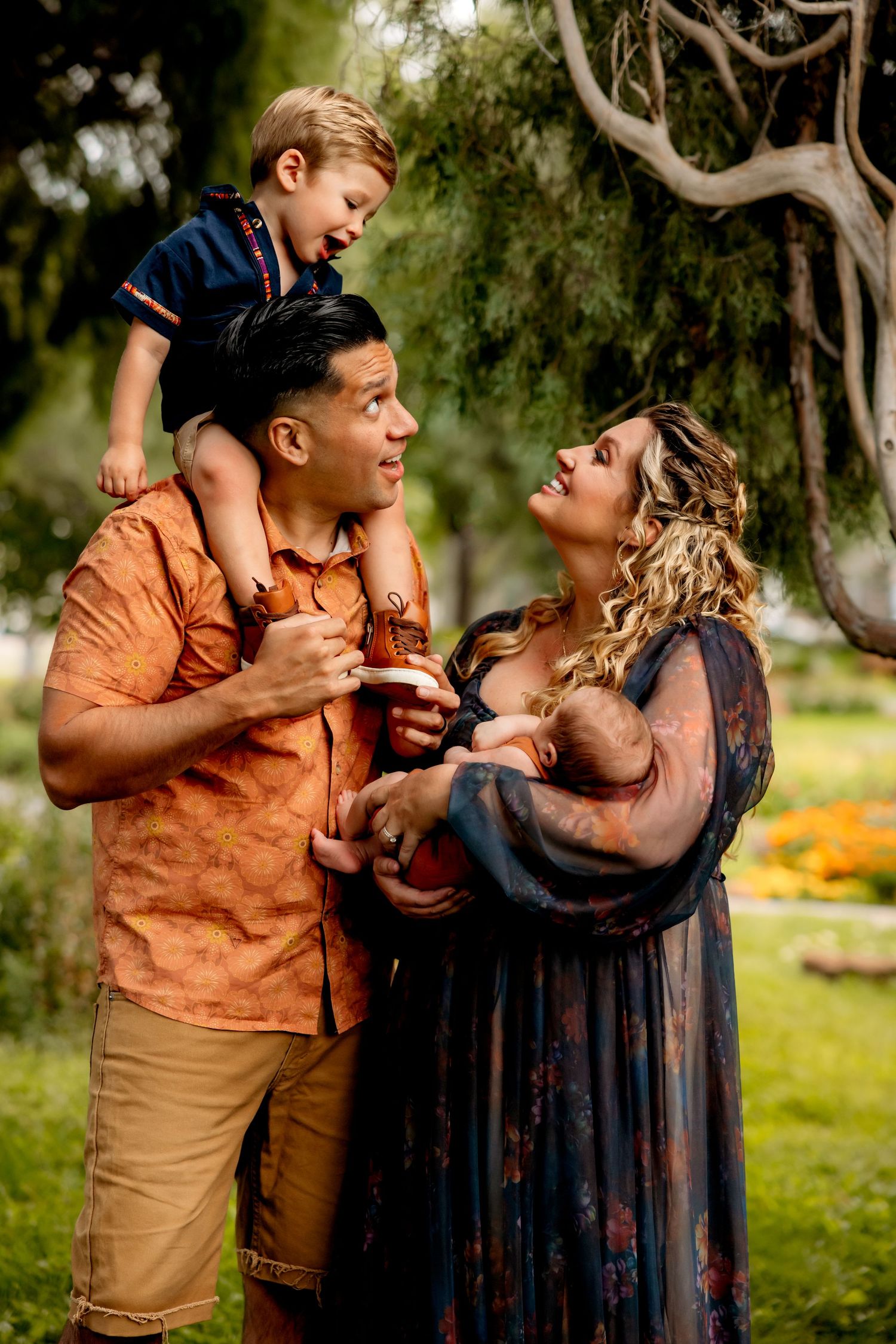 Candid family moment captured in a lush garden setting with natural afternoon light.