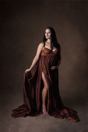 Pregnant mother posing in flowing gown during studio maternity session. Cypress Texas Photographer