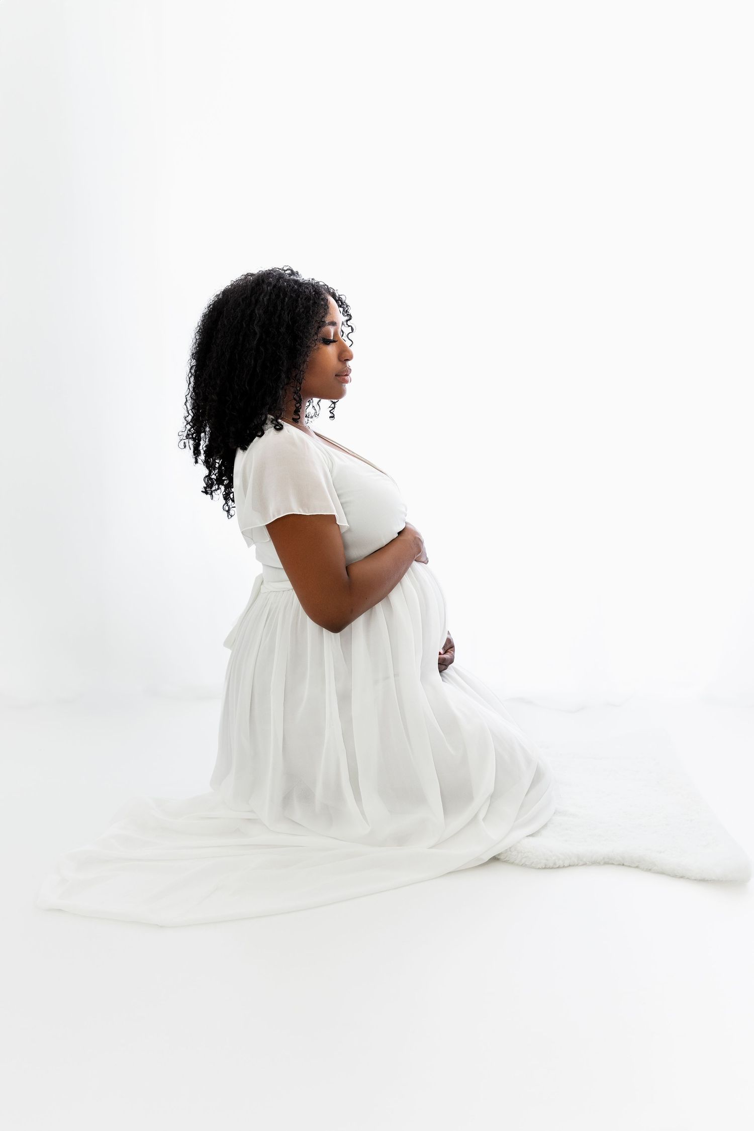 Beautiful Pregnant Woman Kneeling by Window