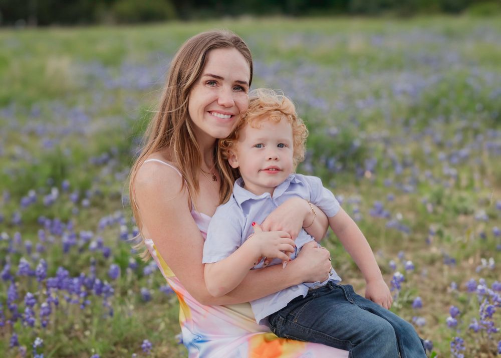 A portrait mom and on in a field of blooming bluebonnets in Texas during springtime. Bluebonnet Mini Session