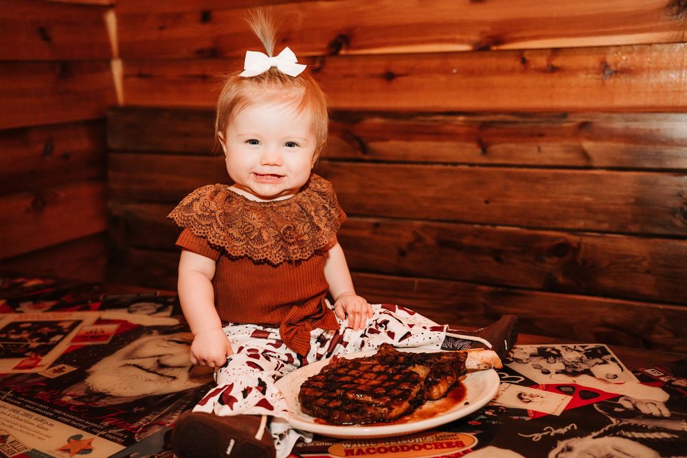 Rustic wood cabin photoshoot with decorative image layouts and brown paper scattered on floor.