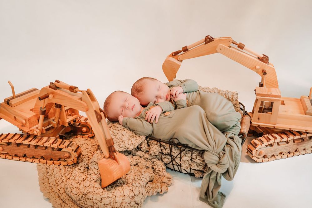 Baby in neutral colored clothing lies on a beige blanket in a series of progressive movement poses.
