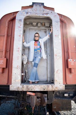 Sacramento portrait photography - portrait of a woman on the back of a train in Old Town Sacramento, Calif.