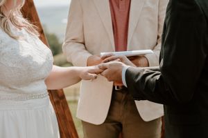 Bride and groom exchanging rings during wedding ceremony at Willow Hill Lodge wedding venue.