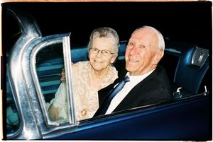 A series of five black and white photos showing a couple smiling together in a car.