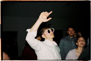A sequence of dark party photos showing silhouettes of people dancing with raised arms against a black background.