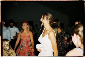 A dark panoramic photo strip showing silhouettes of people at what appears to be an evening social gathering.