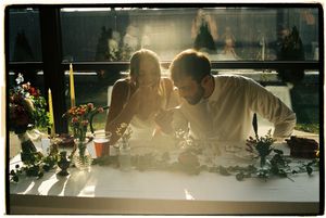 A panoramic view of diners seated at a sunlit restaurant counter with light streaming through the windows.