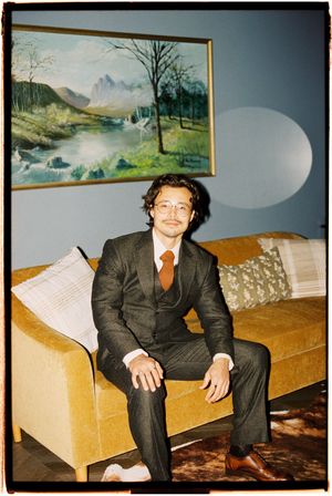 A series of vintage photos showing someone seated on a golden yellow couch with landscape paintings on the wall.