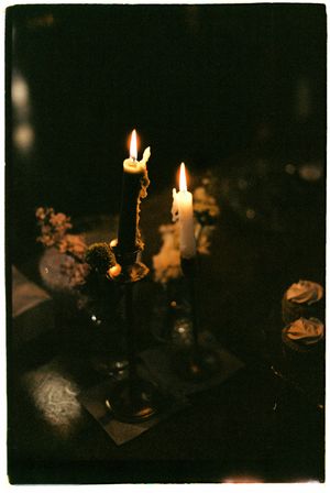A series of moody photographs showing lit candles and cupcakes in dark atmospheric lighting creating a mysterious ambiance.