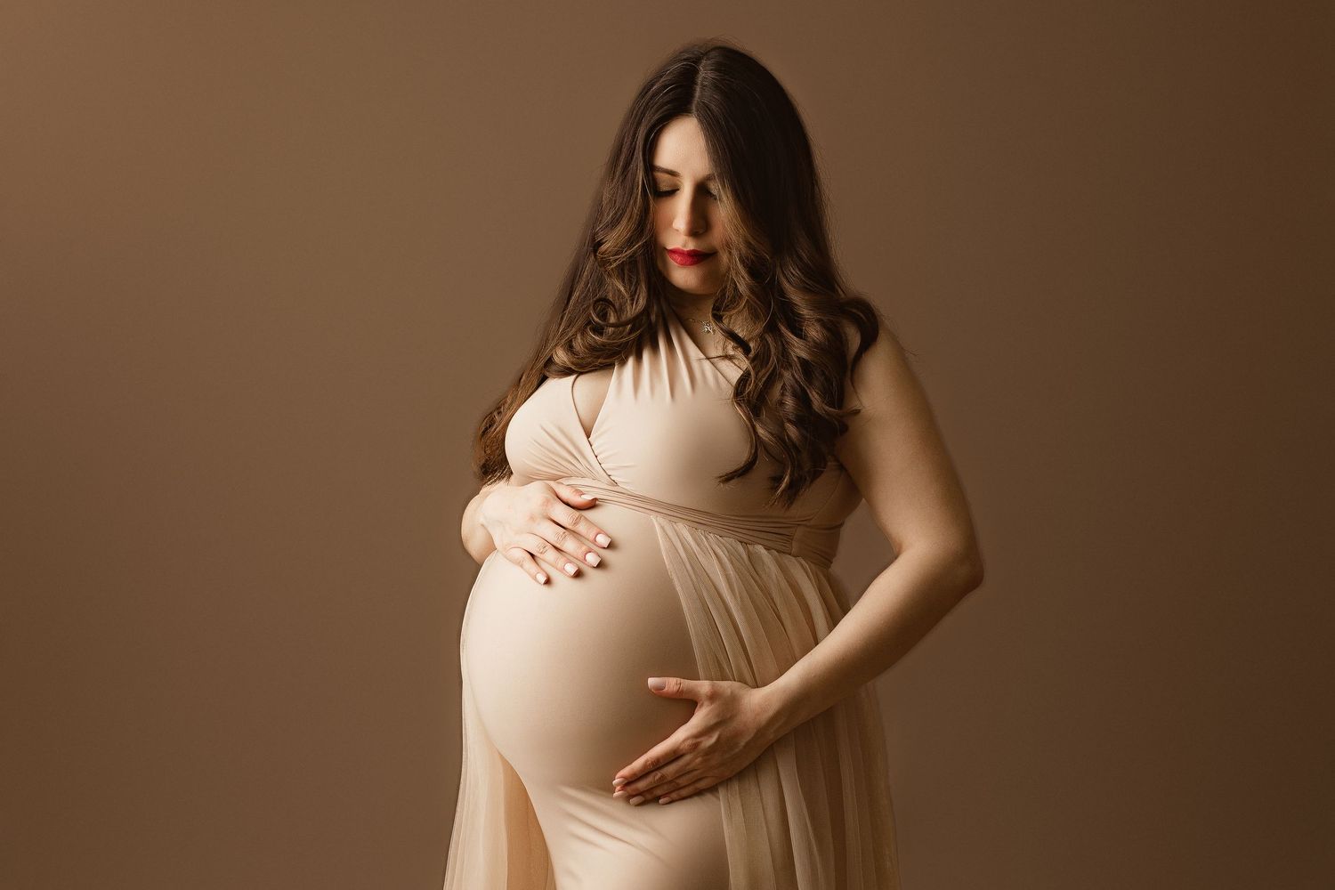 An image of  a proud baby bump during a maternity photo session in a central texas photography studio.