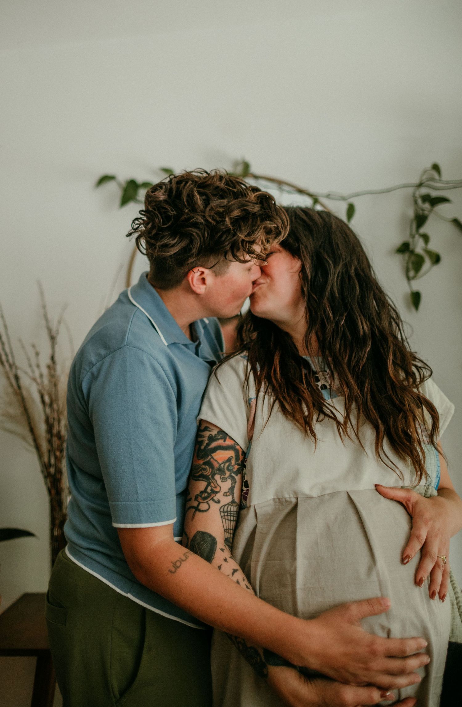 queer couple share a kiss during maternity photo session portland oregon rushes & waves