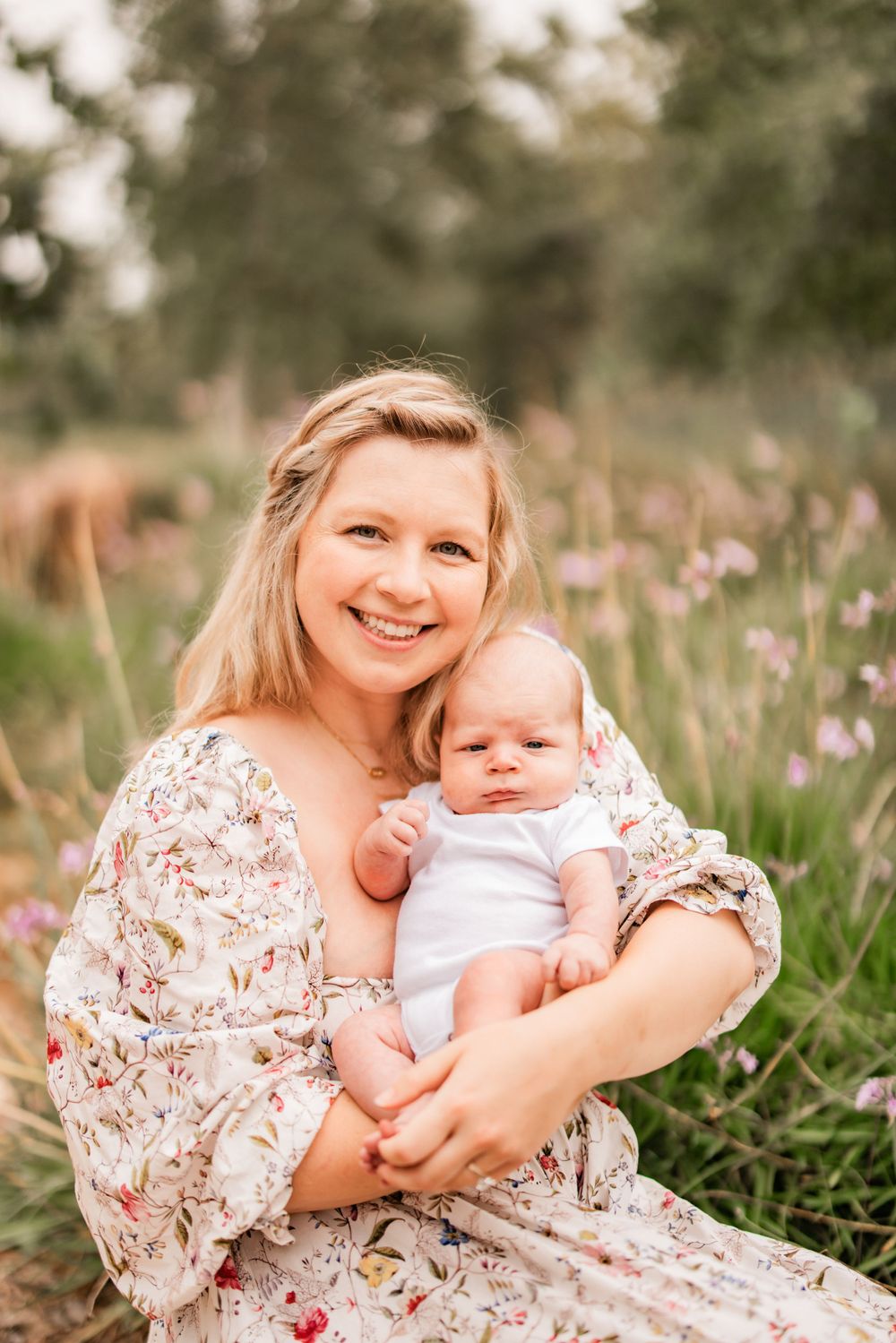 Sweet family portrait amidst purple wildflowers in a natural outdoor setting.