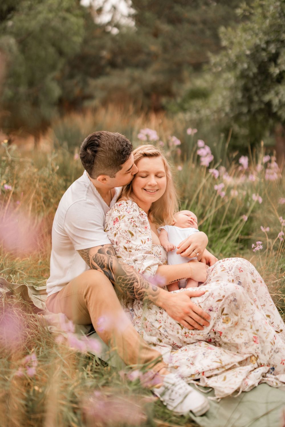 Intimate family portrait in a dreamy wildflower field during golden hour.