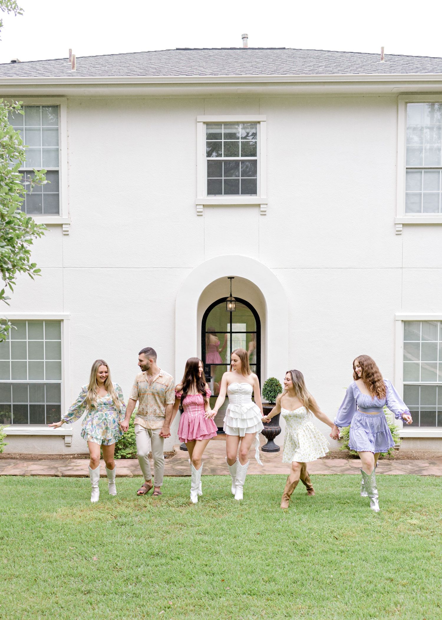 bride & her bridal party, skipping along grass in Austin, TX.