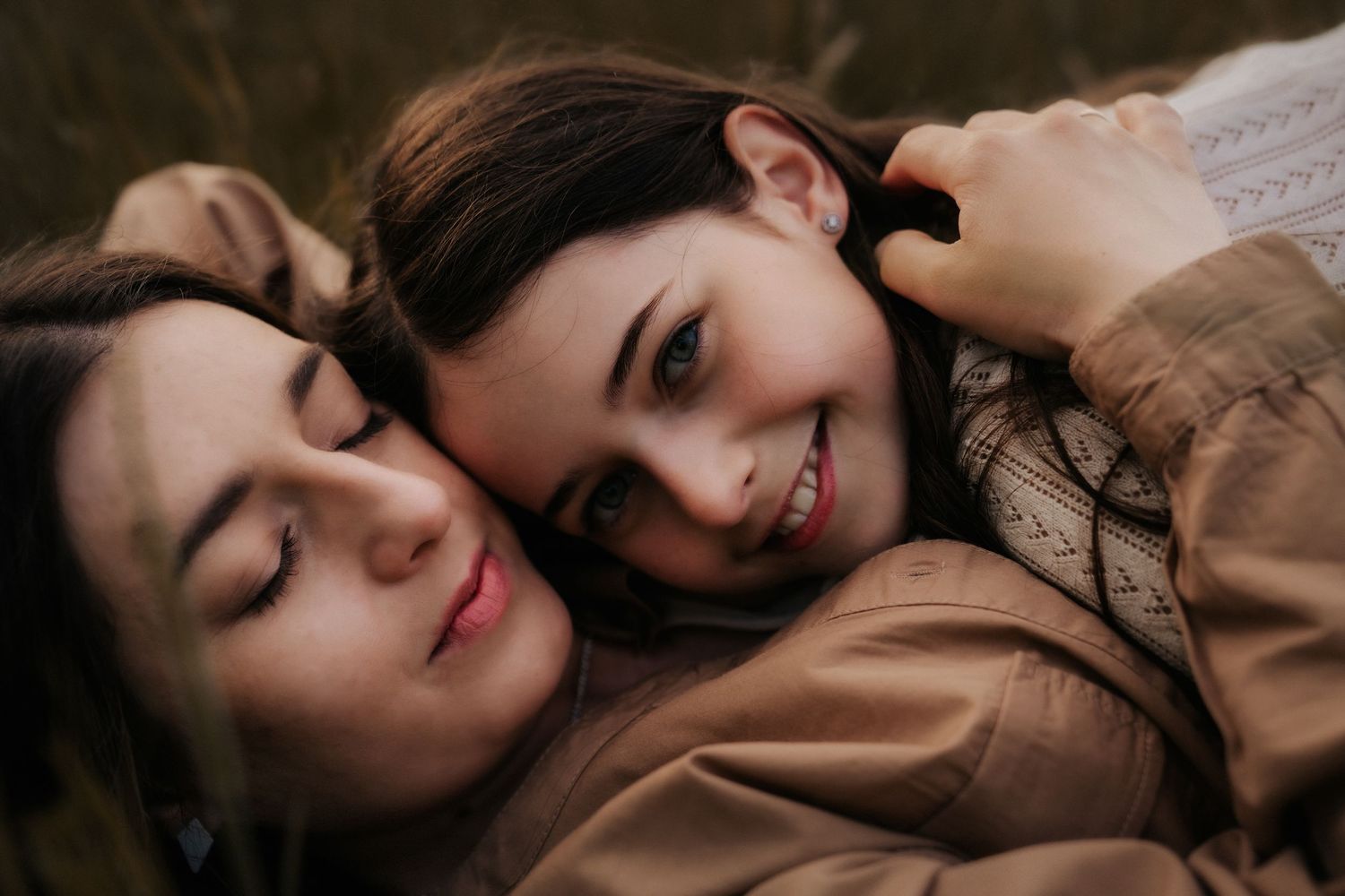 Tender outdoor portrait with mountain stream and rolling hills in background.