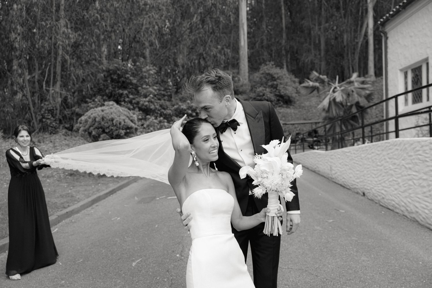Black and white wedding portrait outside a classic white building.