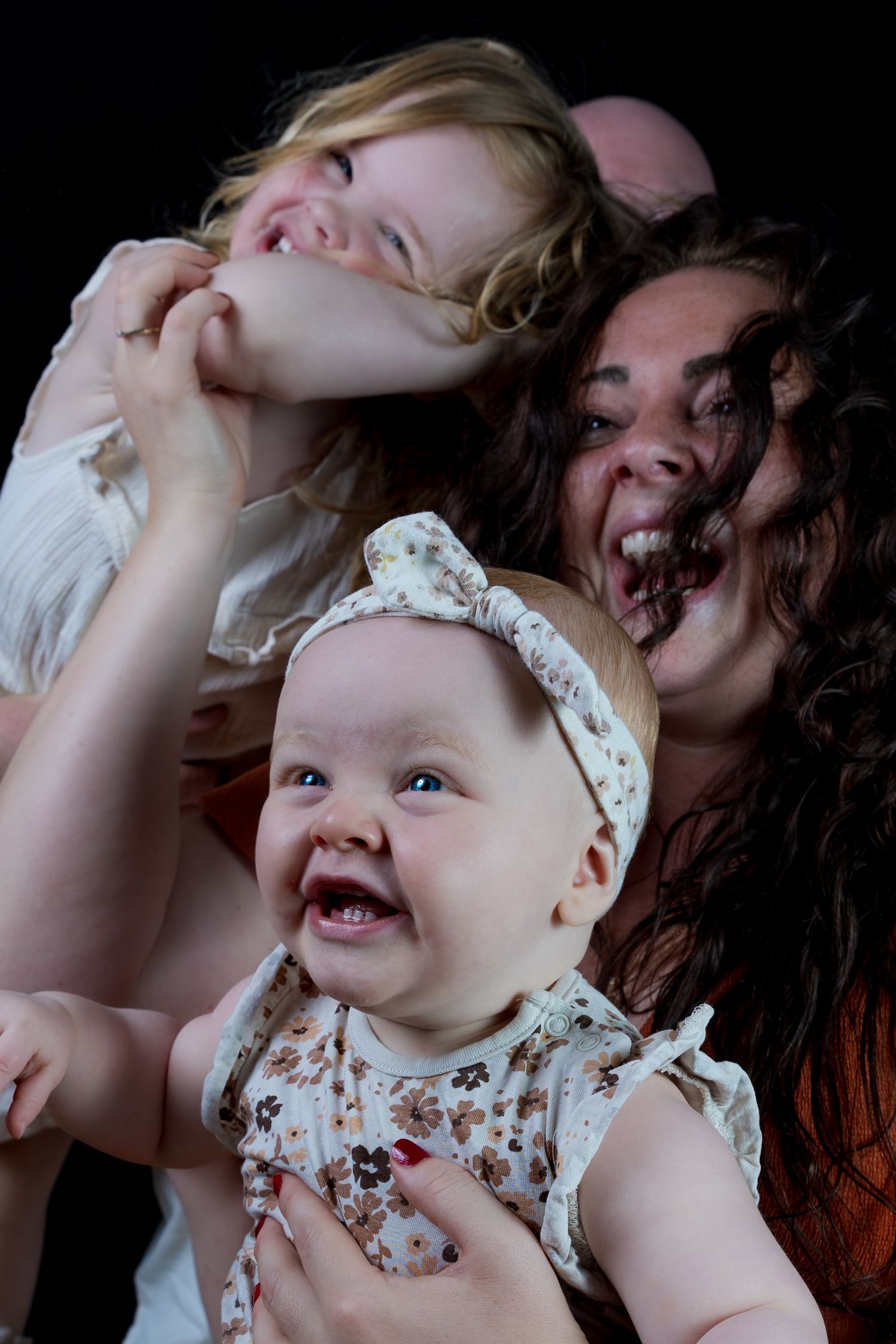 Three people laughing joyfully together in a candid portrait showing genuine happiness and emotion.

- BU Photography -
